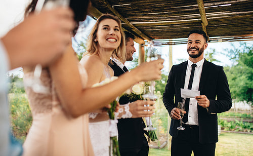 Best man performing speech for toast at wedding reception