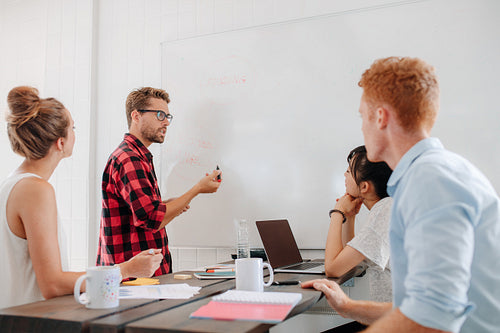 Executive explaining business plans to his coworkers