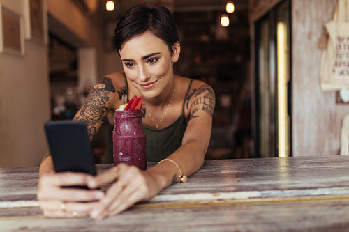 Woman taking a selfie for her food blog