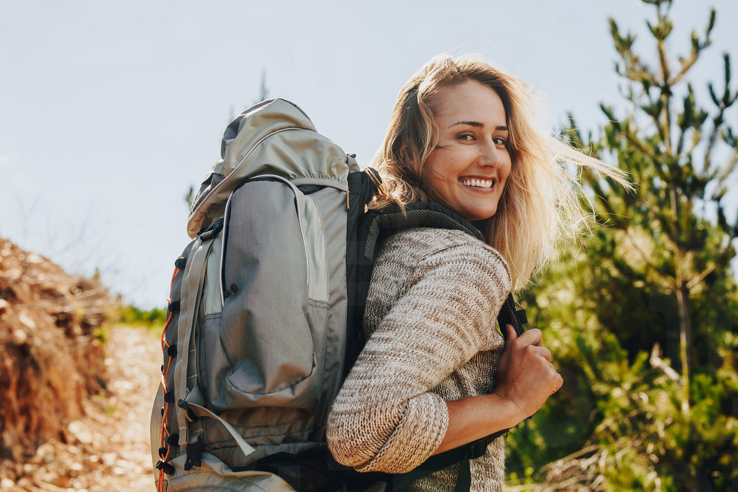 Woman with backpack hiking in nature - Main Image