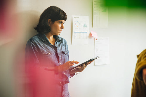 Woman holding digital tablet in office