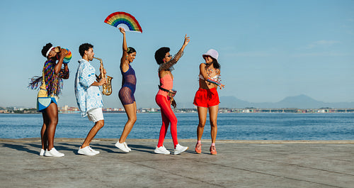 Friends celebrate at the beach carnival