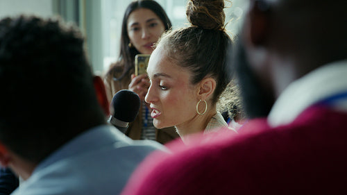 Woman speaks at business conference.