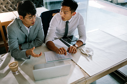 Business people discussing new project in coffee shop