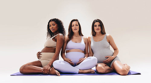Multicultural group of pregnant women exercising for health