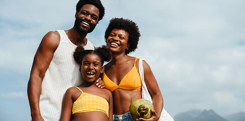 Happy Brazilian family enjoying summer at the beach together