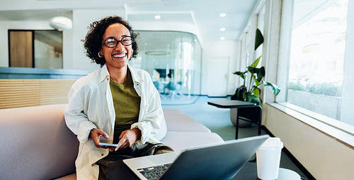 Woman working with laptop in bright modern office