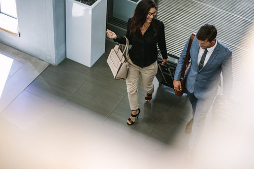 Business people arriving at hotel with luggage