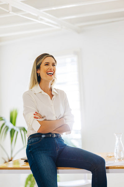 Successful businesswoman laughing cheerfully in a boardroom