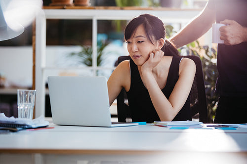 Business people working together on laptop in office