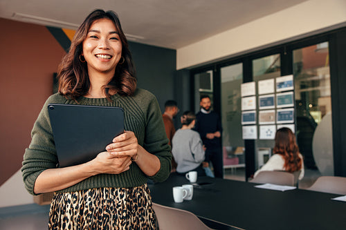 Cheerful businesswoman smiling at the camera in a boardroom