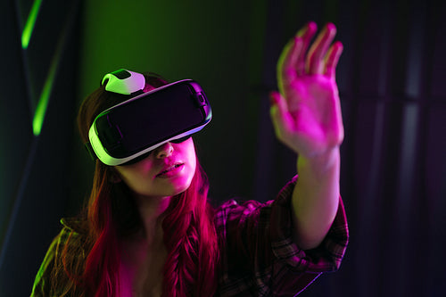 Woman interacting with virtual reality using a VR headset