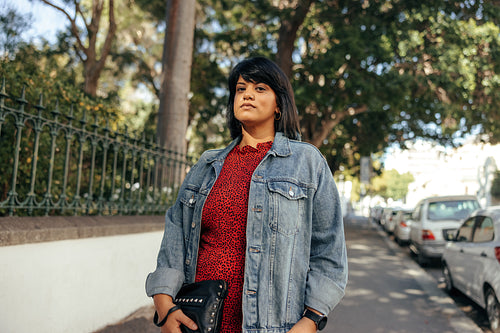 Mid-adult woman standing on a sidewalk in the city