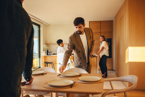 Friends preparing a casual dinner together in a modern home kitchen space