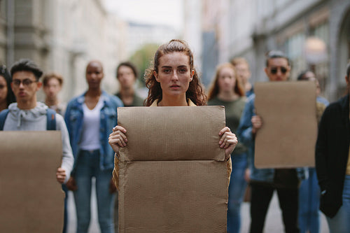 People demonstrating with blank placards