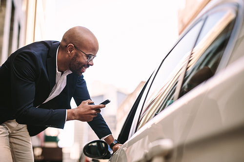 Businessman talking with cab driver on road