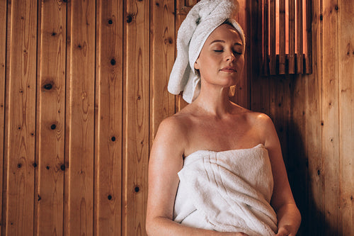 Woman sitting in a spa with eyes closed