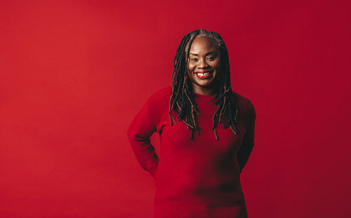 Woman with dreadlocks smiling at the camera happily