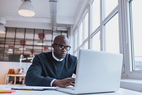 Businessman working on laptop in office