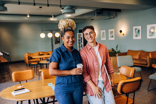 Smiling coworkers standing together in a casual office environment