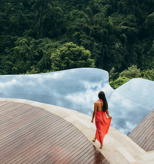 Young woman walking at the poolside