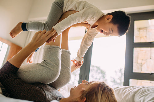 Carefree mother and son playing at home