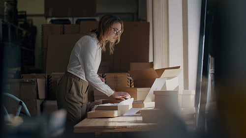 Woman preparing the product for shipping as per the order