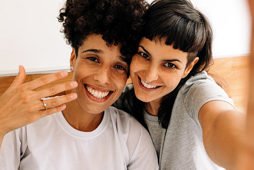 Lovers taking an engagement selfie