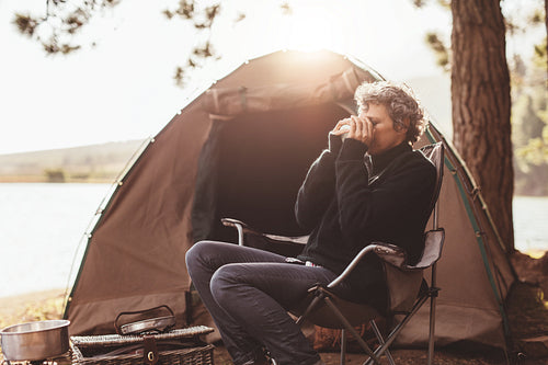 Mature woman at campsite drinking coffee