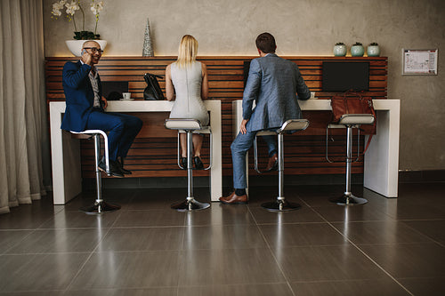 Travelers in airport at free internet service corner