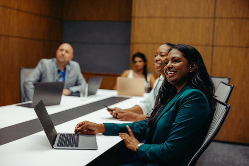 Confident Indian businesswoman leading a team meeting
