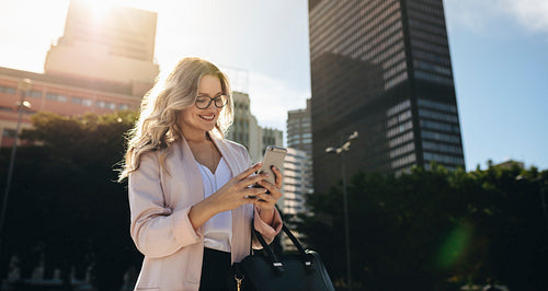 Businesswoman texting while commuting to work