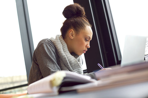 Woman taking notes for her study