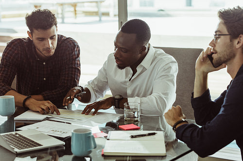 Three businessmen in a meeting working together