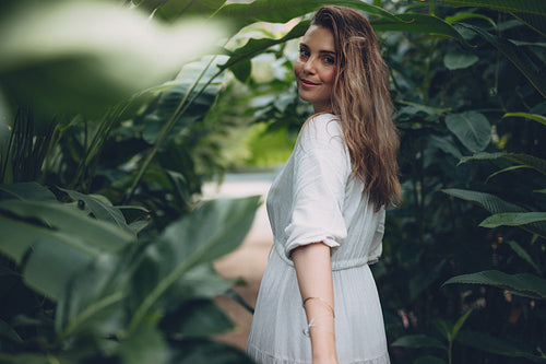 Beautiful female model in greenhouse