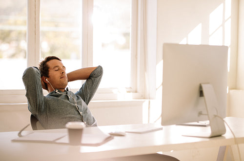 Freelance entrepreneur relaxing sitting in front of computer