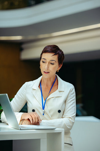 Confident businesswoman working on a laptop in corporate office