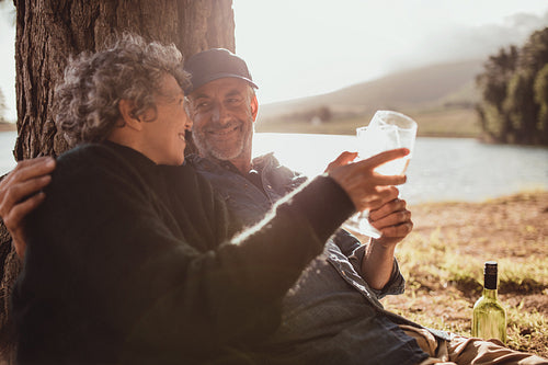 Senior couple enjoying camping near a lake