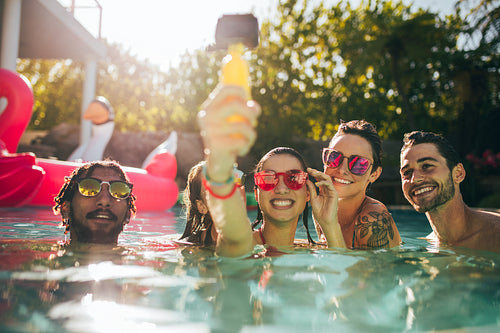 Friends taking selfie in the swimming pool
