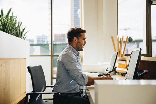 Young executive working on computer in office