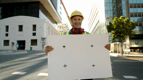 Happy construction worker holding empty placard