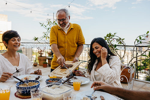Family enjoying a Brazilian churrasco on a sunny outdoor patio