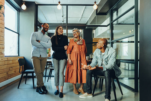 Business colleagues laughing happily in a modern office