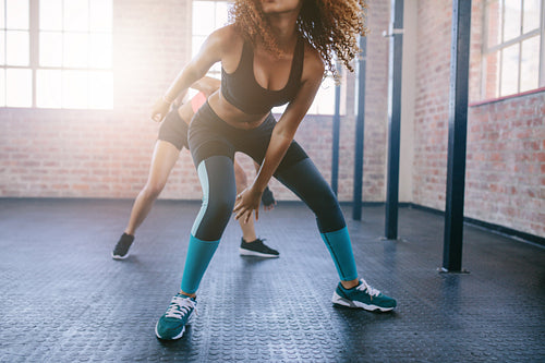 Young females doing running workout in the gym.
