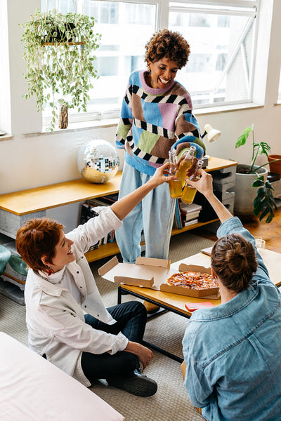 Colleagues sharing a meal in a casual office setting