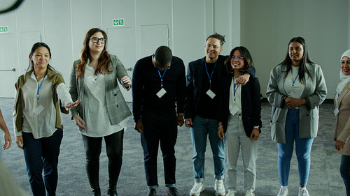 Diverse business team huddling, collaborating with hands together, showing unity and success