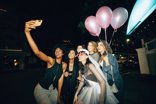 Group of friends celebrating a bachelorette party with balloons and smiles