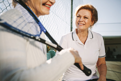 Senior women relaxing after a game of tennis