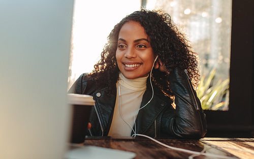 Woman working on laptop sitting at a table