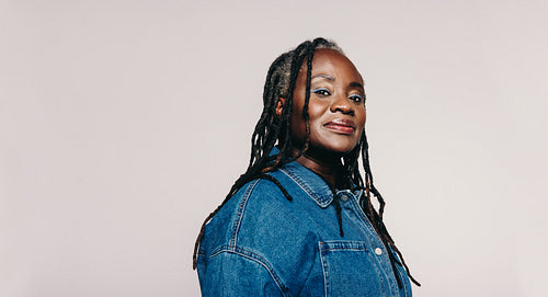 Fashionable mature woman with dreadlocks looking at the camera